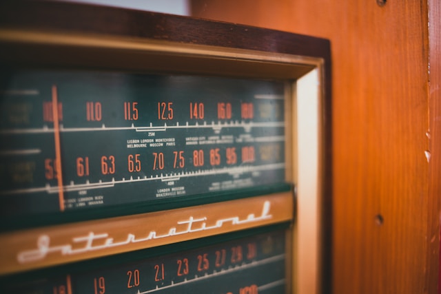 An old radio tower dial tuning into a clear, crisp signal amid static