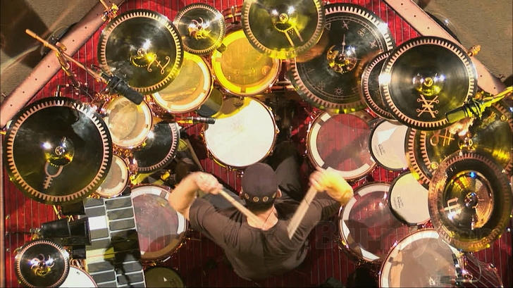 An overhead view of drummer Neil Peart surrounded by a massive arrangement of cymbals and drums