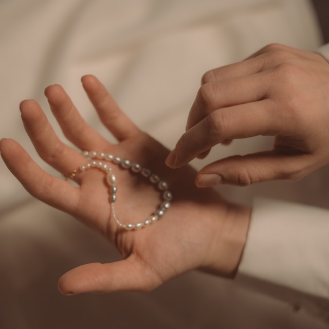 A string of pearls in an open hand