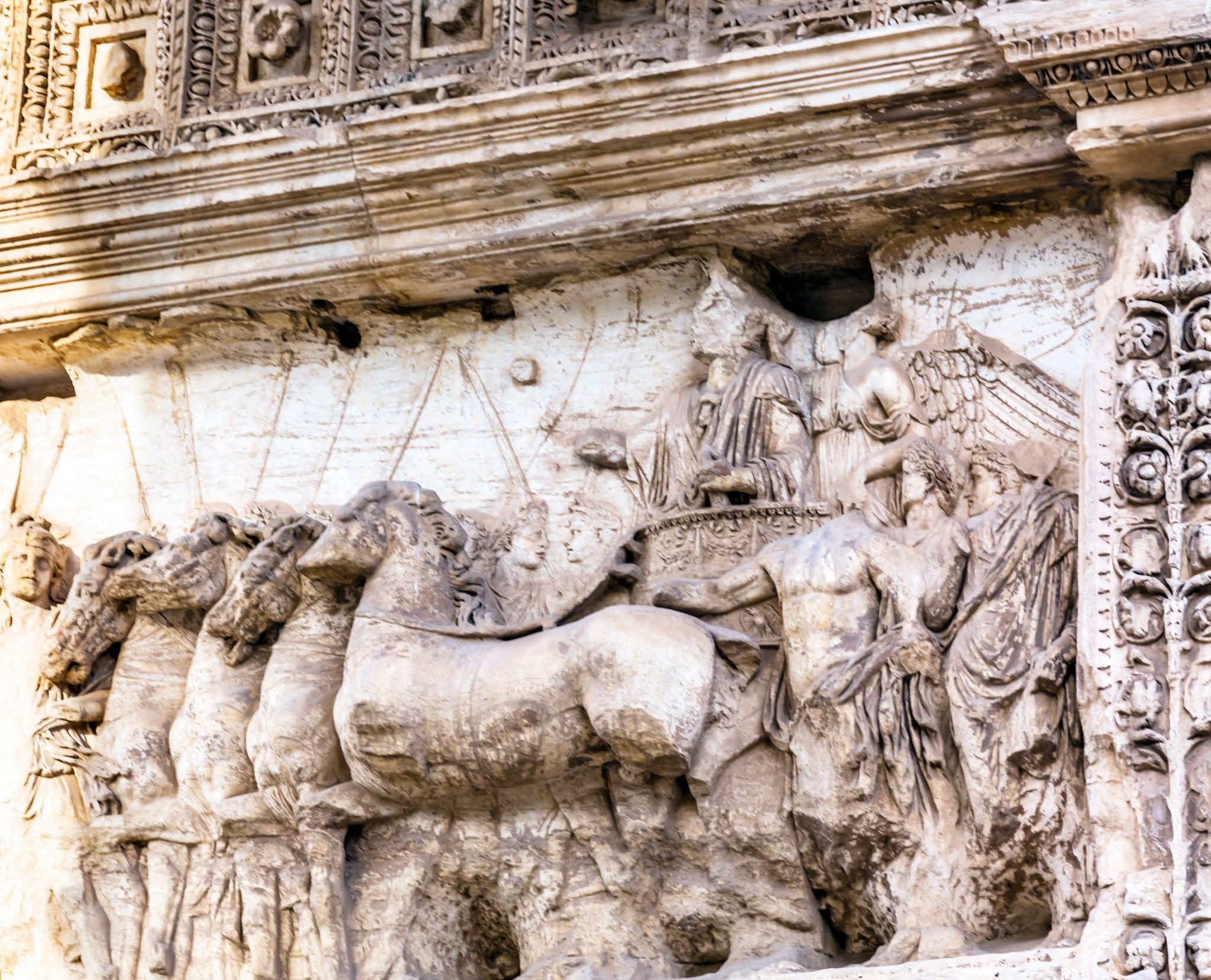 An ancient stone relief depicting a Roman triumphal procession with standard-bearers