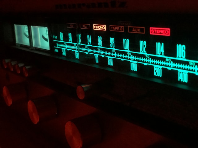 A clean macro shot of an analog radio tuning gauge locked onto a clear signal